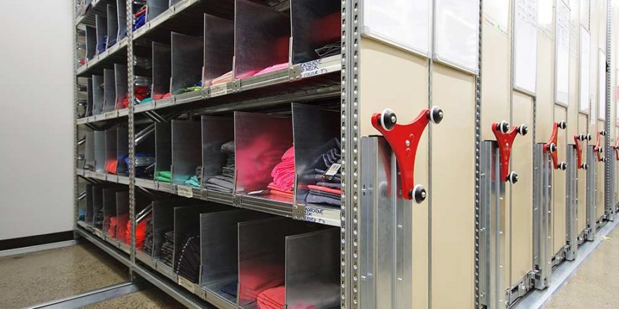 an apparel stockroom with cloths stored in compactus shelving